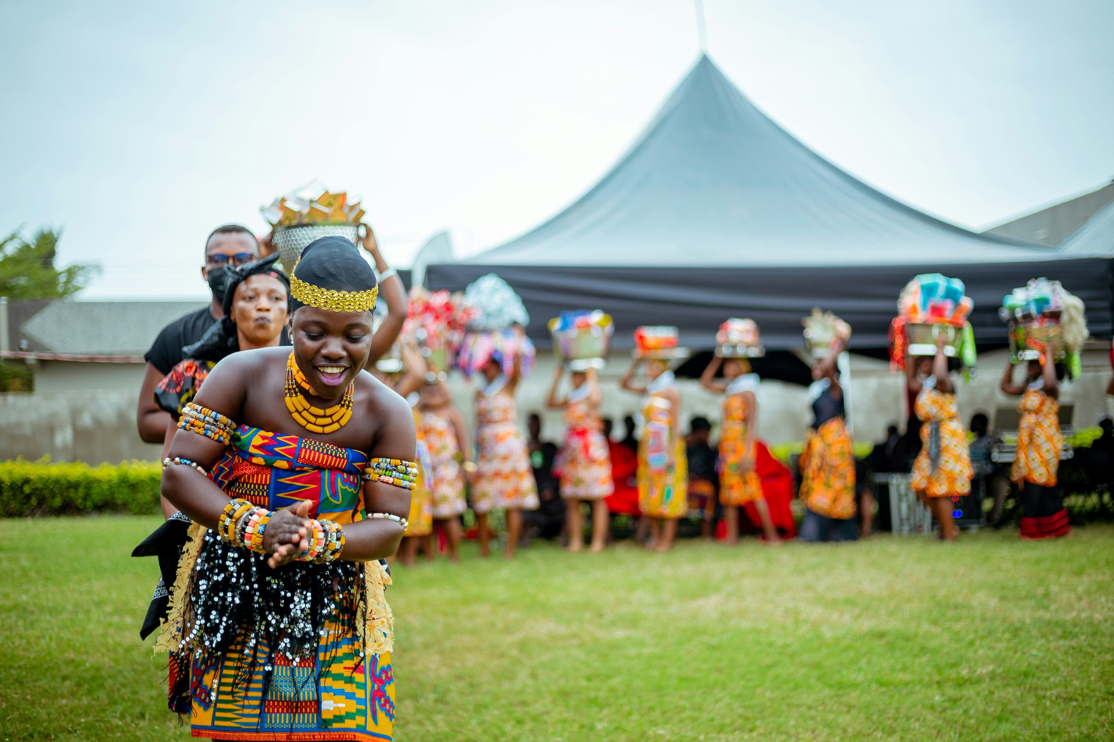 African dancer in traditional kente clothing celebrating culture